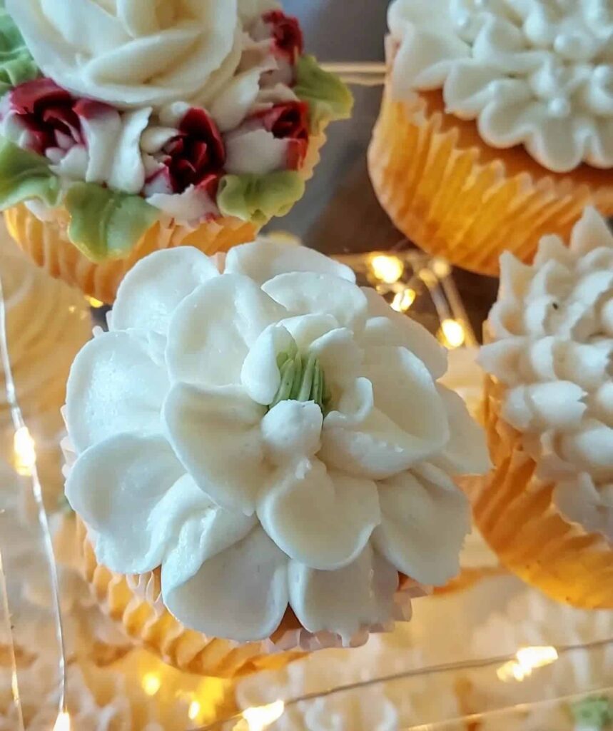 Cupcakes with floral frosting designs included in catering cost per person for weddings and events in Elgin