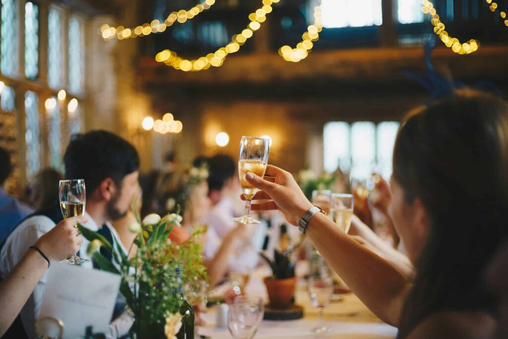 Wedding celebration with guests raising glasses during catering near Elgin Illinois event